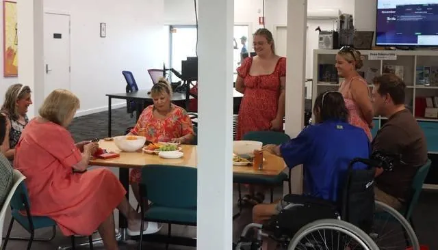 Guests and staff sharing the finished meal together at the table