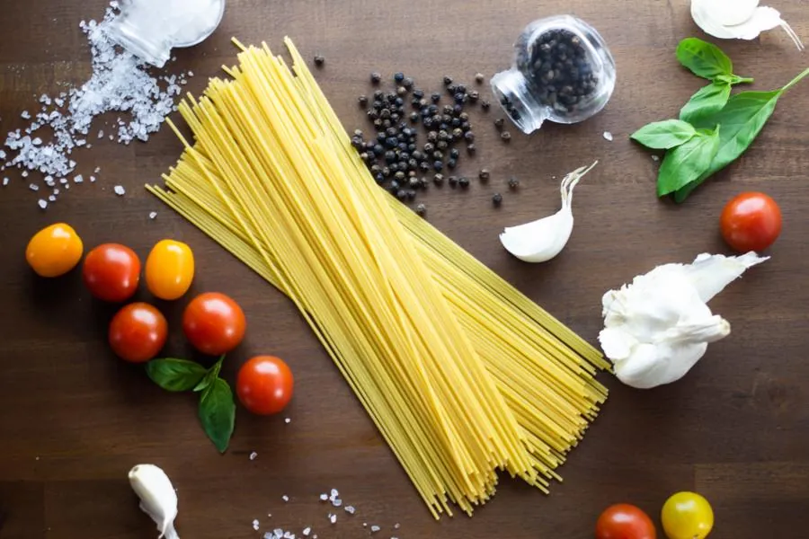 Spaghetti, tomatoes, garlic and basil laid out ready for cooking