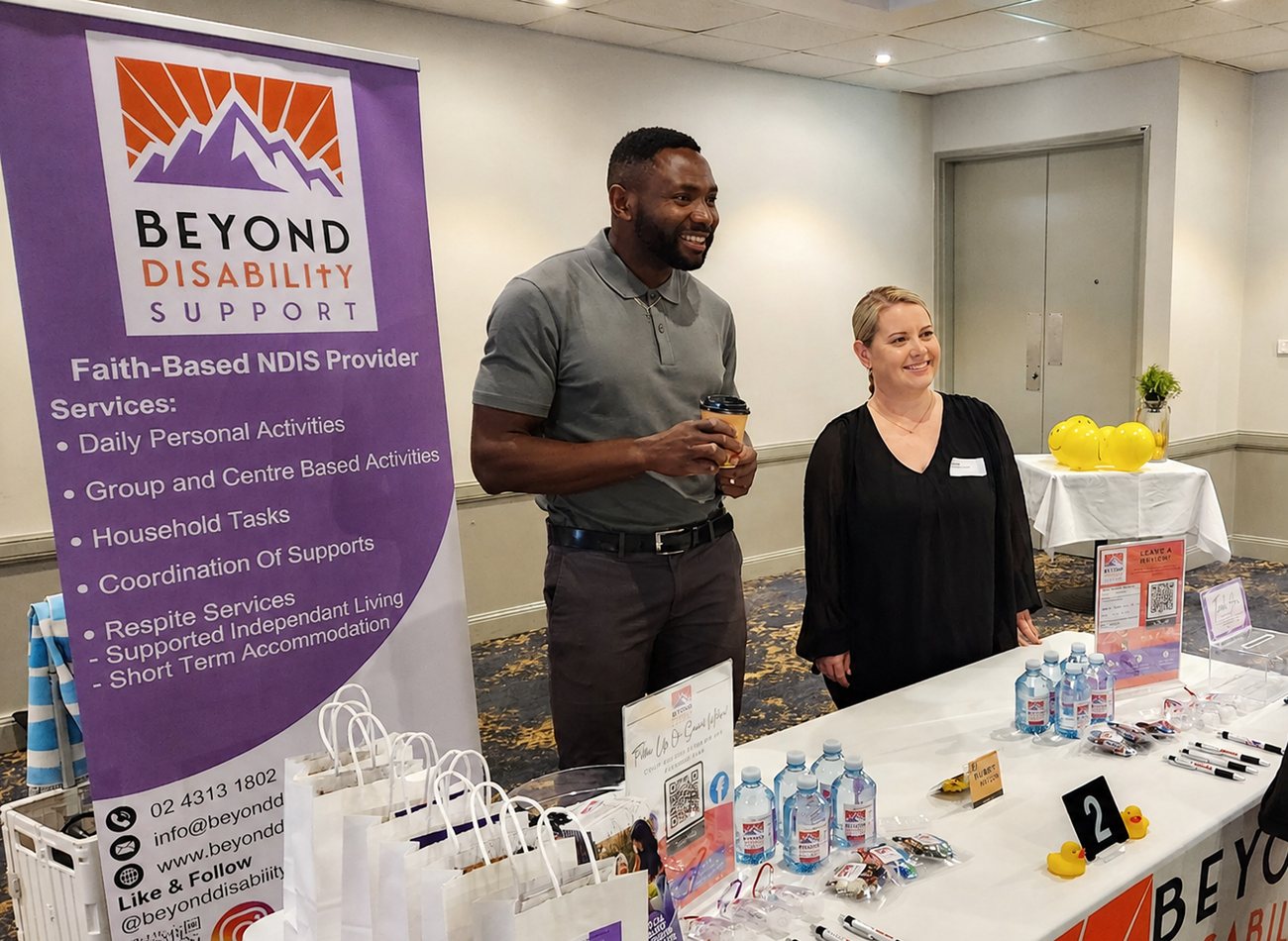 Two Beyond team members chatting at the Beyond stand during a community expo