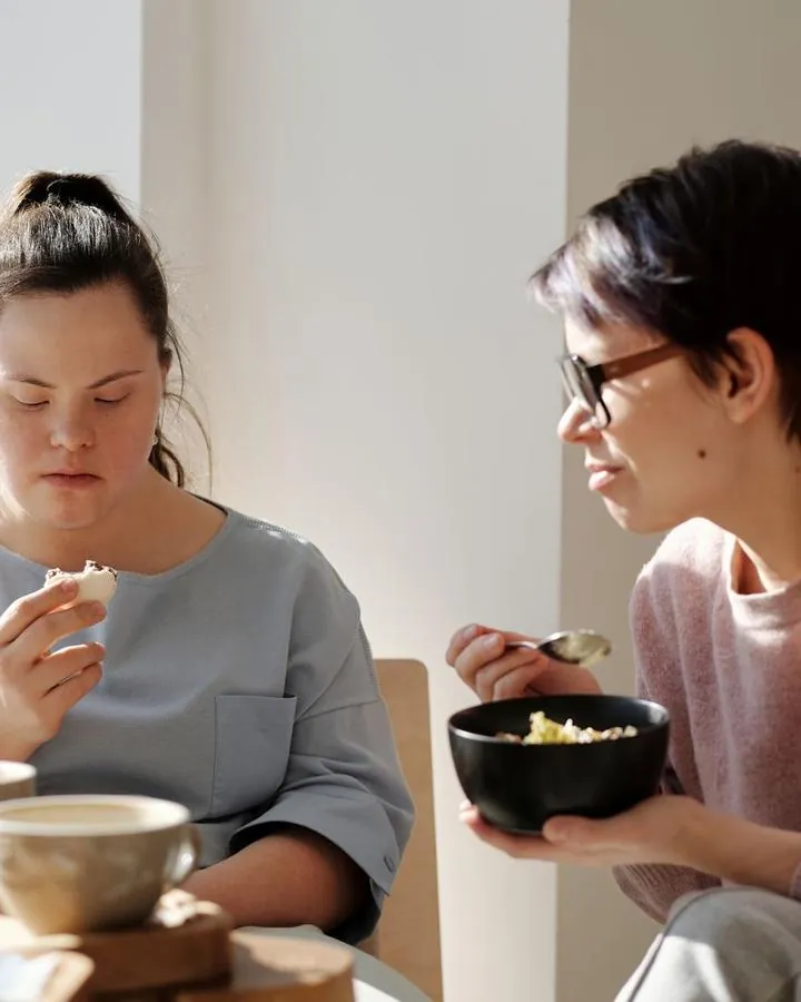 Two women sharing a meal and conversation at a table