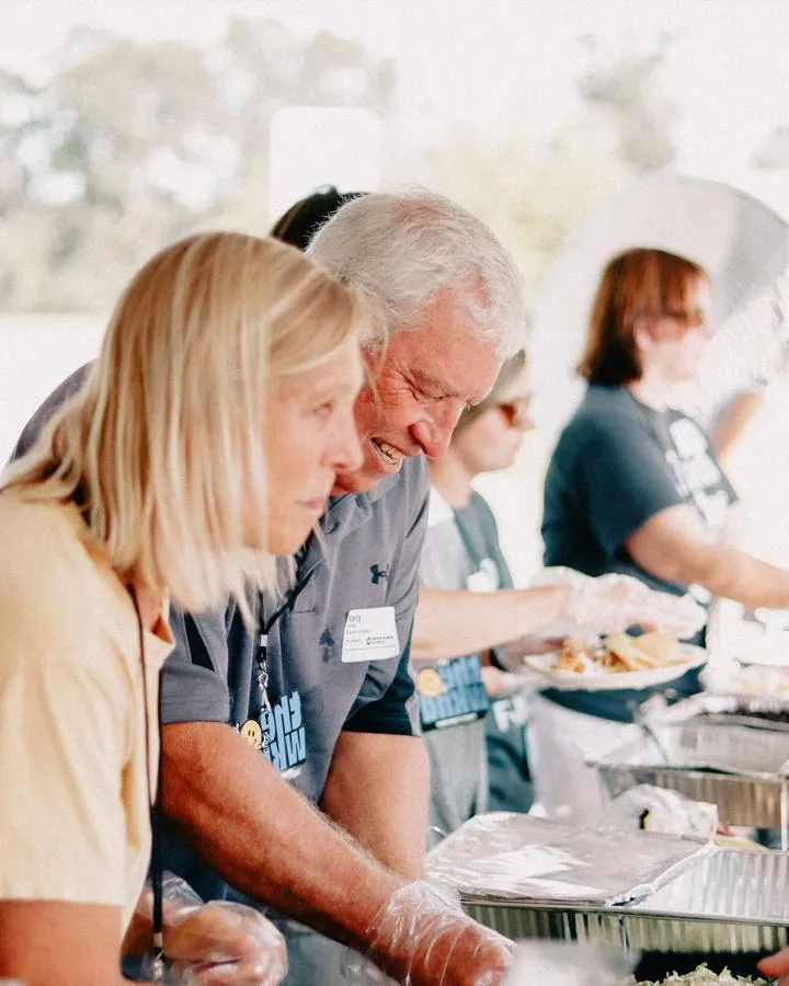 Volunteers serving food at a church community lunch