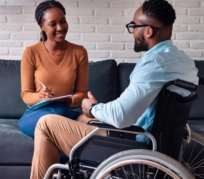 Firefly-caucasian-lady-sitting-in-a-wheelchair-talking-to-a-black-man-sitting-on-a-couch-who-is-hol_1024.jpg.bv_resized_desktop.jpg.bv